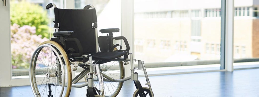 Wheelchair indoors at hospital. Find Total and Permanent Disability Insurance.