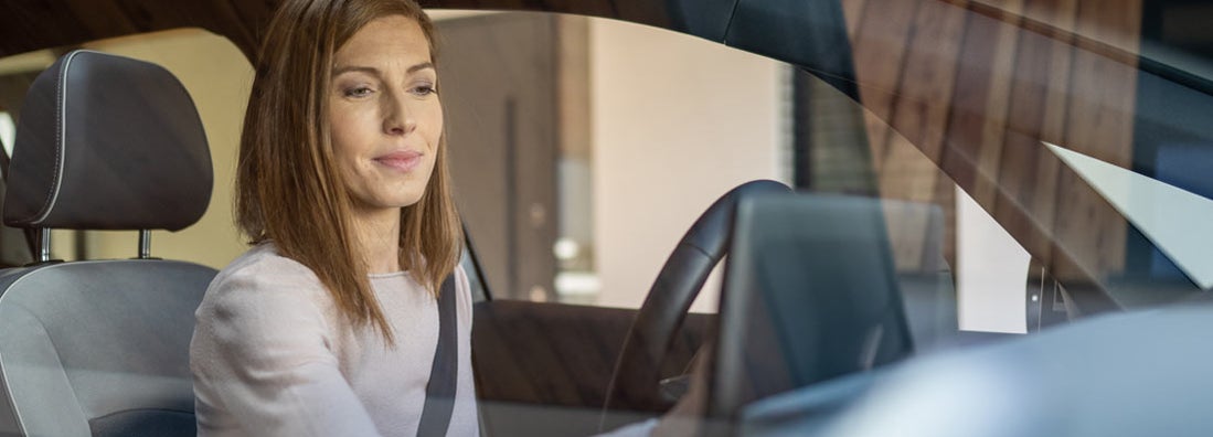 Woman using global positioning system in car. Find Abilene, Texas car insurance.
