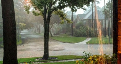 Heavy rain and flooding in suburb from hurricane. Rising flood rates.