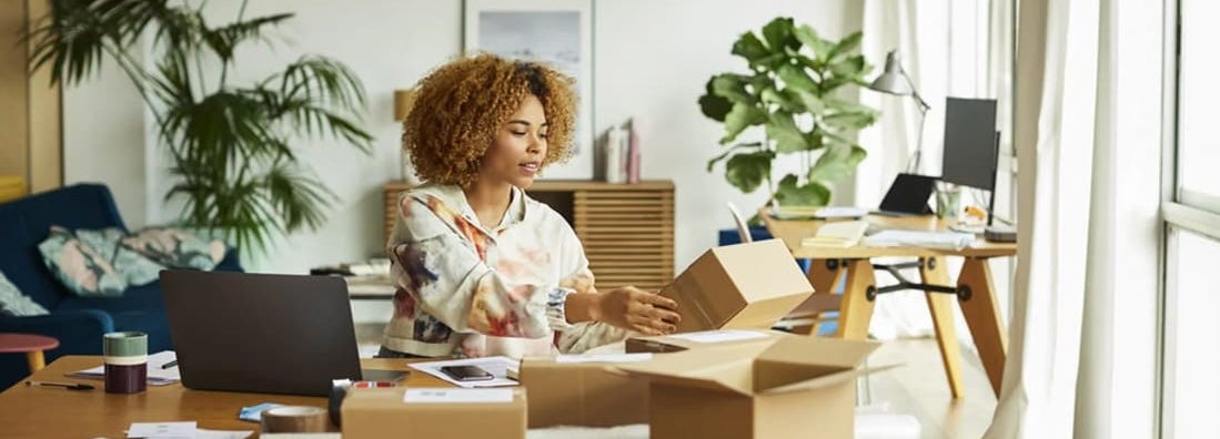 Professional analyzing packaging while sitting at table. Find Bixby, Oklahoma business insurance.