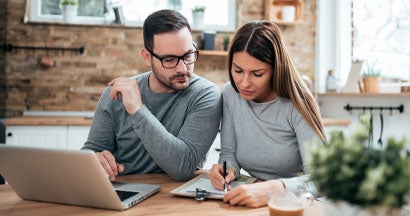 Young couple researching insurance in cozy home. Mistakes every insurance shopper needs to avoid.