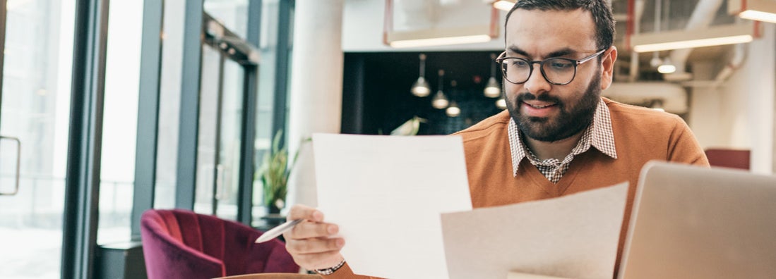 Man reviewing paperwork. Find Accounts Receivable Insurance.