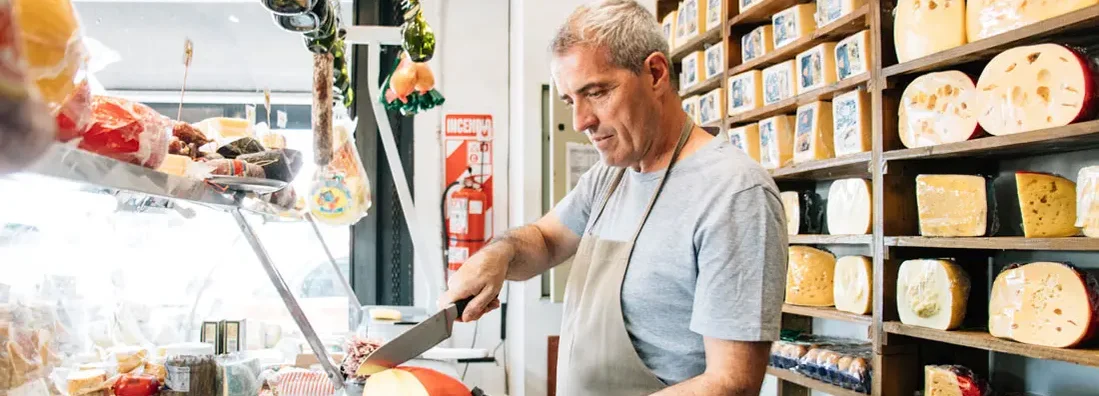 Cheesemonger serving customer orders. Find Parker, Colorado business insurance.