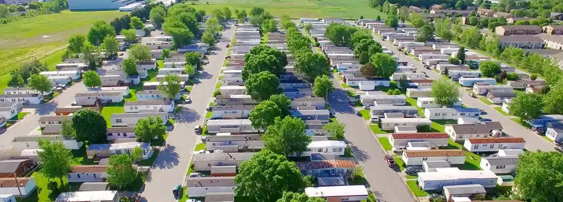 Mobile home park on sunny summer morning. Find Alabama Mobile Home Insurance.