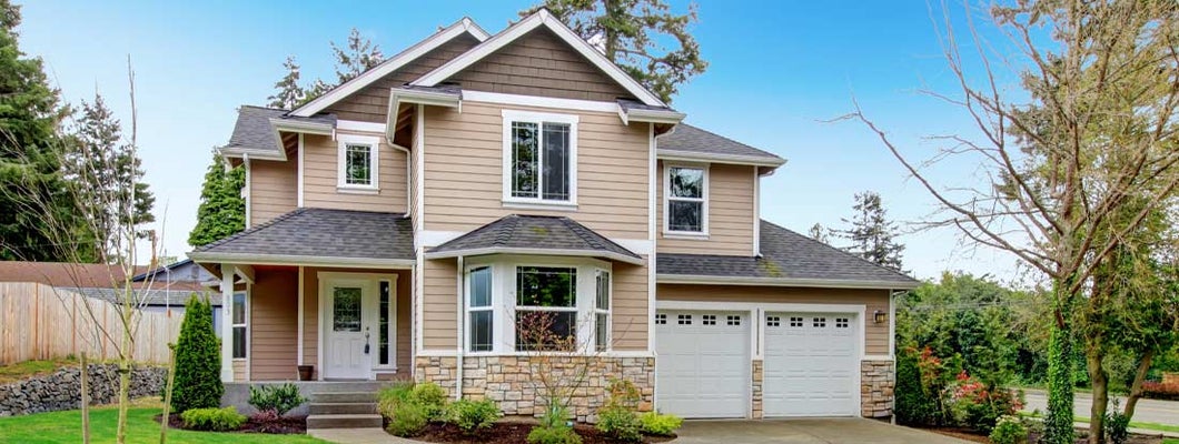 Beautiful beige siding house with stoned base. Find Philadelphia homeowners insurance.