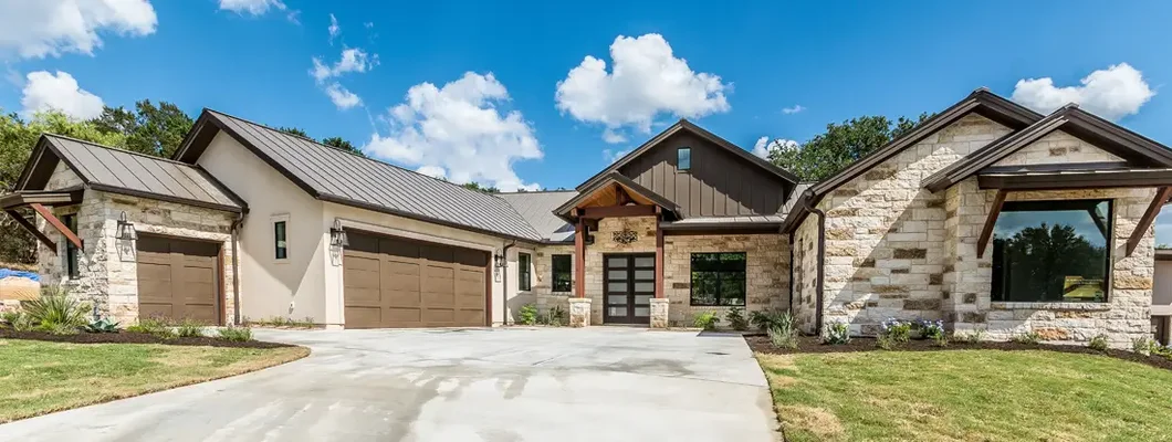 Blue skies above home with shades of brown. Simpsonville, South Carolina home insurance.