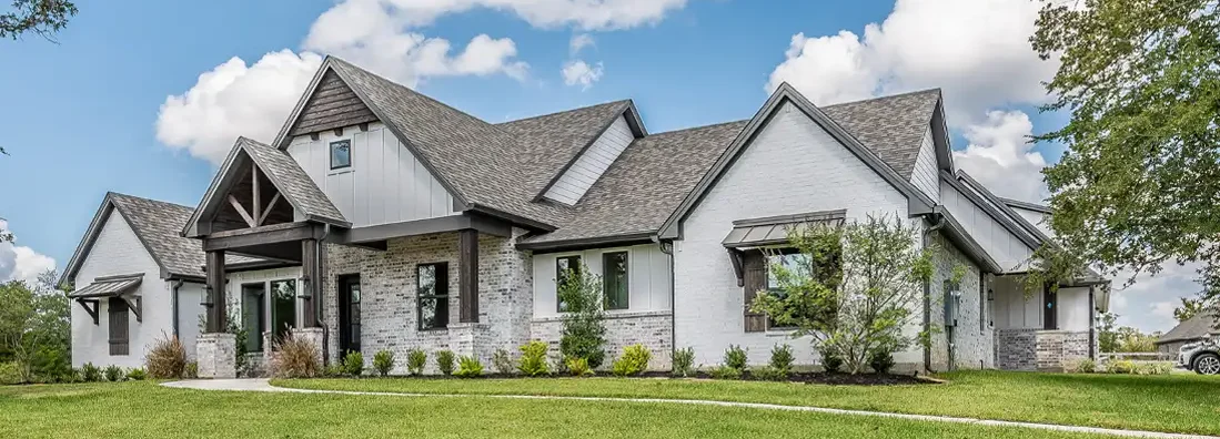 Beautiful white and stone facade on home. How to Find the Best Homeowners Insurance in Augusta, Maine. 