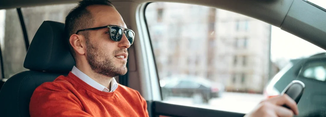 Young man driving a car. How to Find the Best Car Insurance in Saco, Maine.