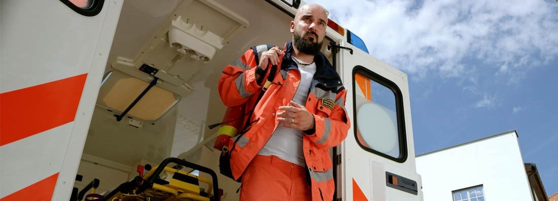 Paramedic getting out of ambulance. Find Paramedic Insurance.