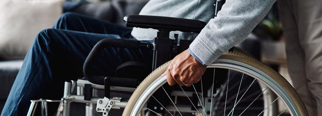 Low angle shot of man moving in his wheelchair at home during the day. Find Individual disability insurance.