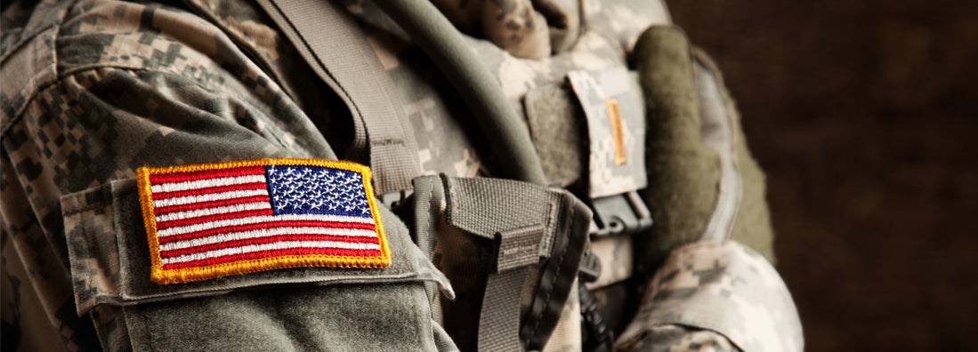 US Army Soldier in Universal Camouflage Uniform. Military and veteran car insurance discounts.
