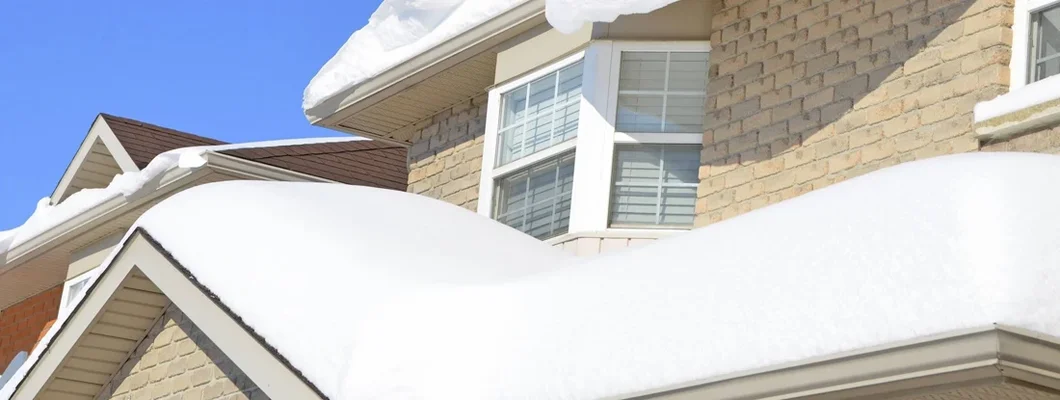 Closeup of snow pile up on a roof. What kind of snow damage will homeowners insurance cover? 