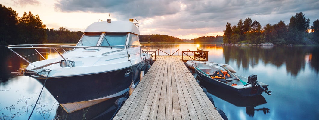 Wooden pier with boats at sunset