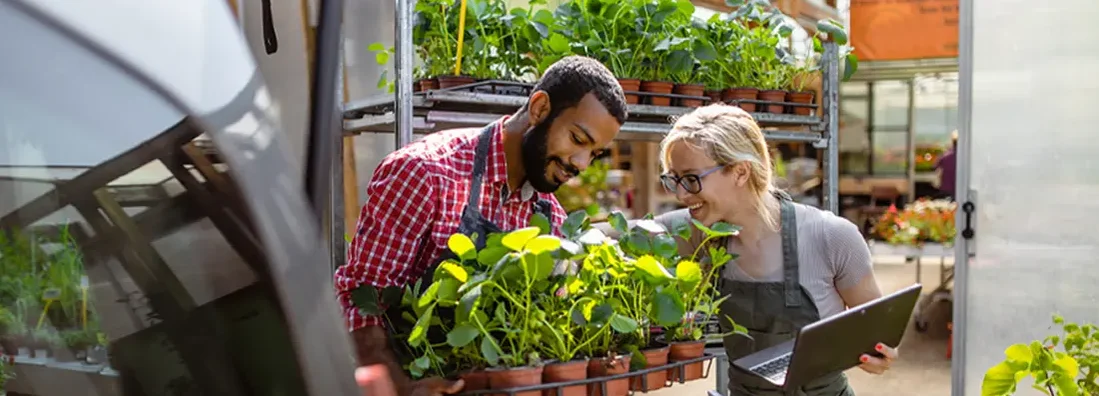 Garden center workers transporting plants in a van. Find Colorado Commercial Vehicle Insurance.