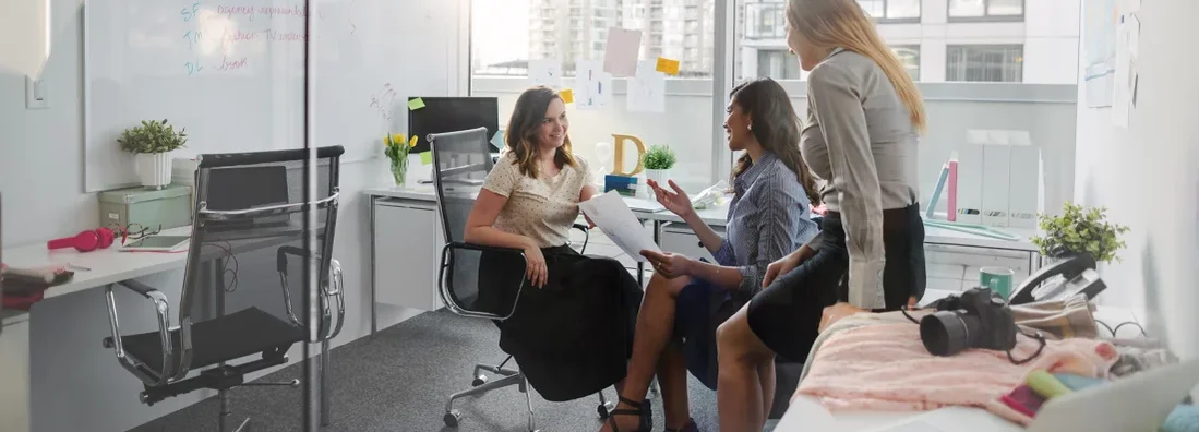 Small group of women sitting within creative office interior discussing plans and ideas. Haddonfield, New Jersey Business Insurance. 