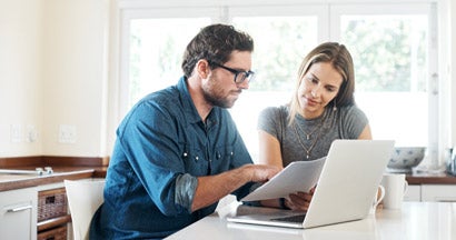 Young couple working on their finances together at home