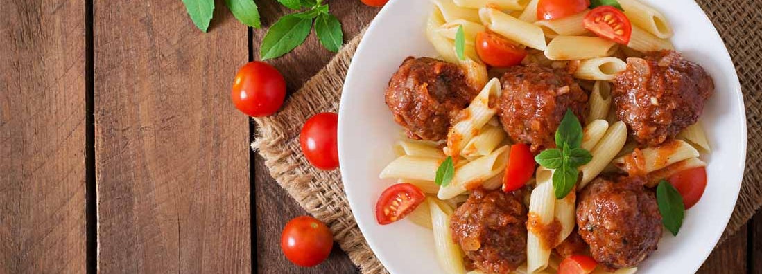 Penne pasta with bison meatballs in tomato sauce