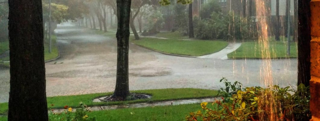 Heavy rain and flooding in suburb from hurricane. Rising flood rates.