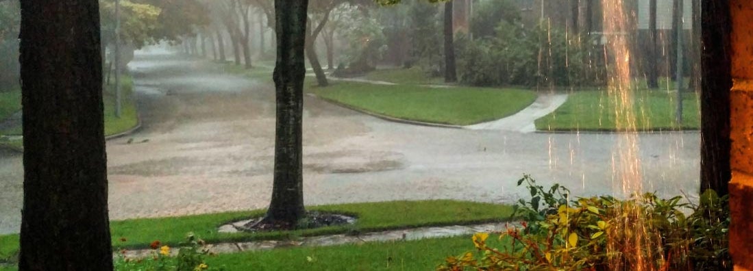 Heavy rain and flooding in suburb from hurricane. Rising flood rates.