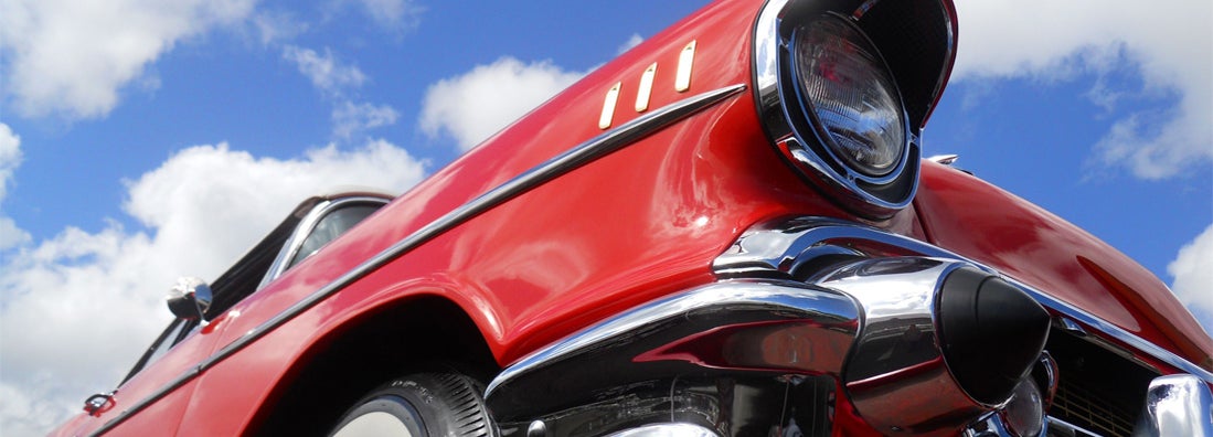 Close up of a beautifully restored 1957 Chevy Bel Air convertible, as seen at a car show. 
