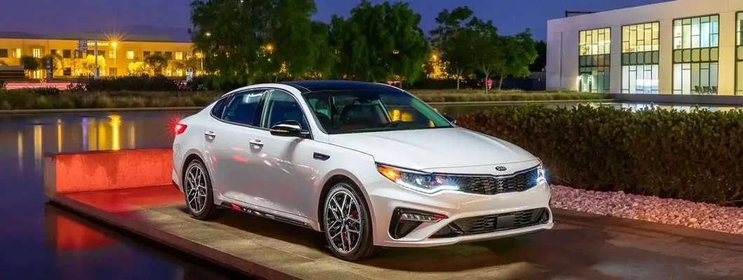 White Kia Optima. Find Kia Insurance.