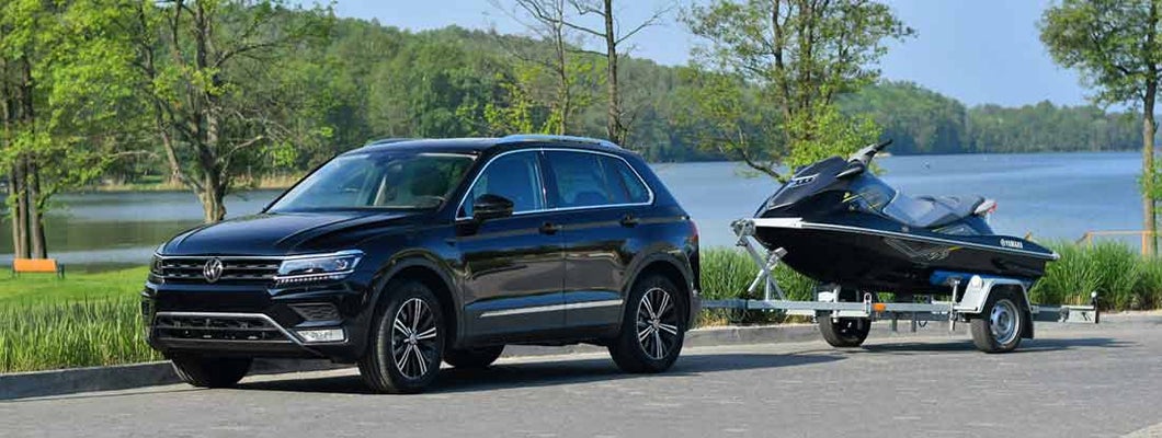 Car towing personal watercraft on trailer. Find trailer Insurance.