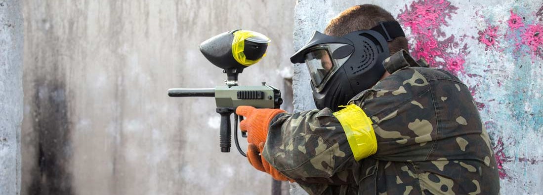 Guy with a paintball gun. Find Paintball Insurance.