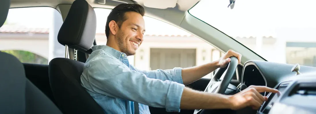 Male driver using the GPS navigation map on the car. Glendale, Arizona Car Insurance.