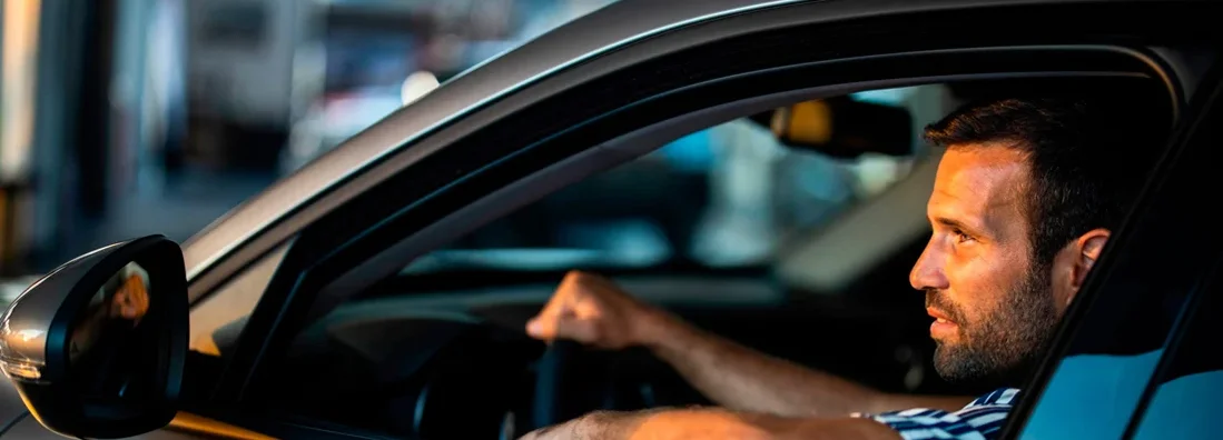 Man driving. Find Leawood, Kansas car insurance.