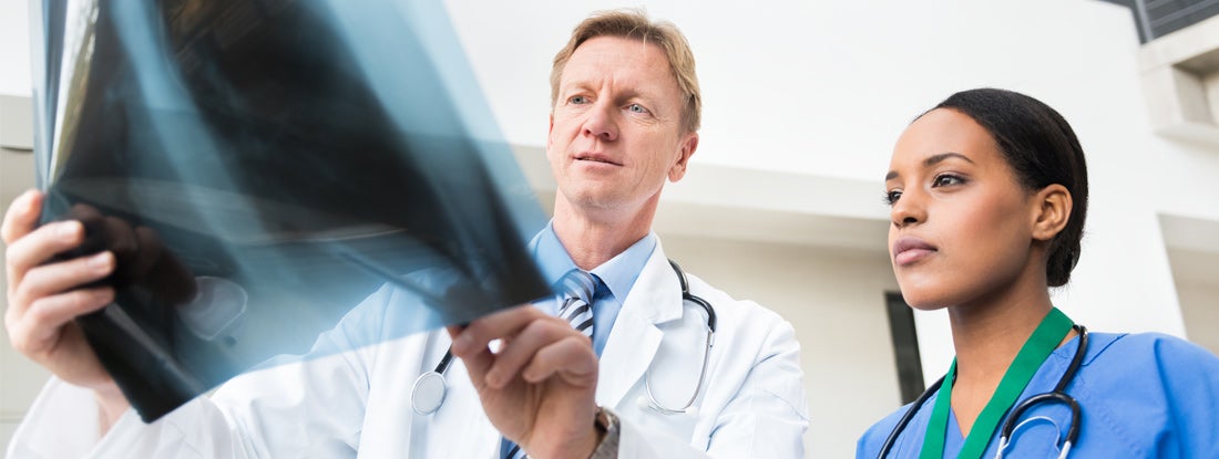Doctor and physician assistant with x-ray