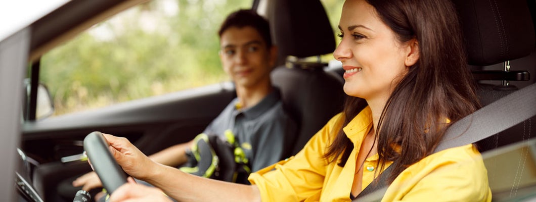 Mother driving her son to the school. Find Austin Texas car insurance.