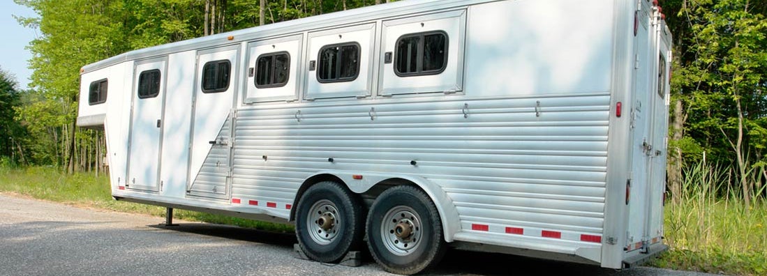 Large horse trailer parked before loading horses. Find horse trailer dealer insurance.