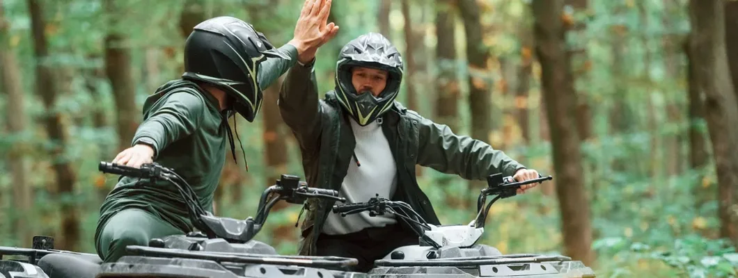 Two ATV Riders in the forest together. Find ATV Liability Insurance.