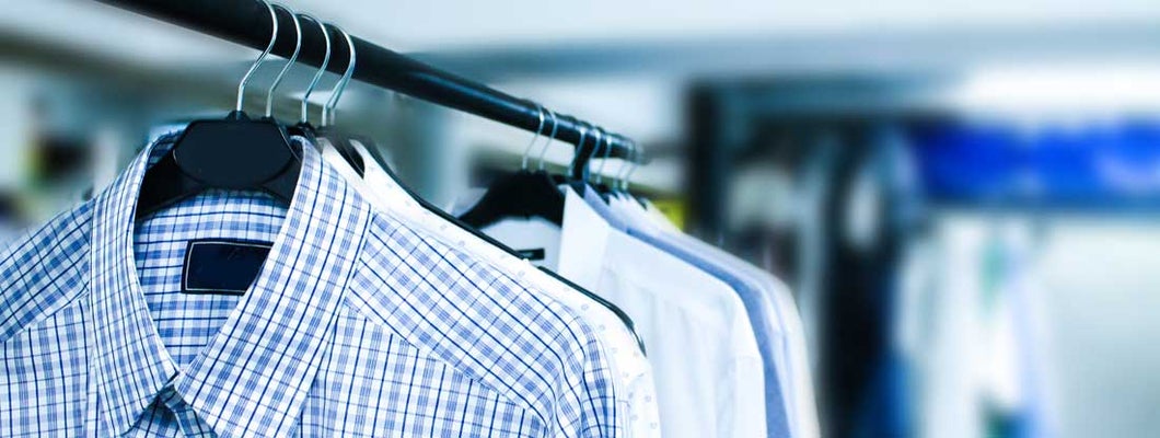 Men's shirts hanging at dry cleaners. Find Dry Cleaner Insurance.