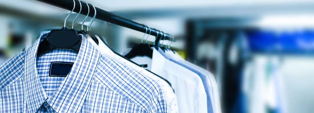 Men's shirts hanging at dry cleaners. Find Dry Cleaner Insurance.