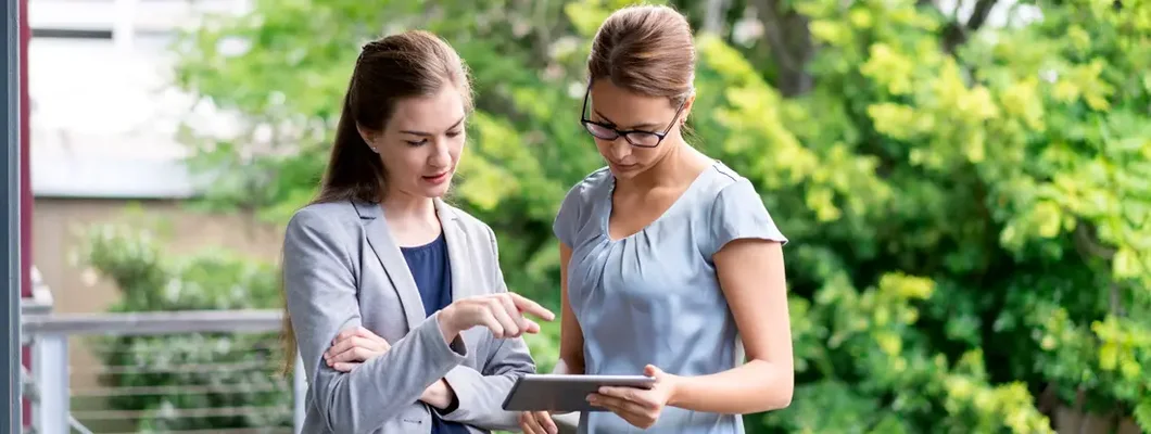 Landlord with digital tablet on balcony. Find Louisiana landlord insurance.