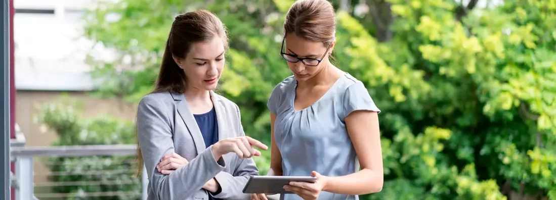 Landlord with digital tablet on balcony. Find Louisiana landlord insurance.