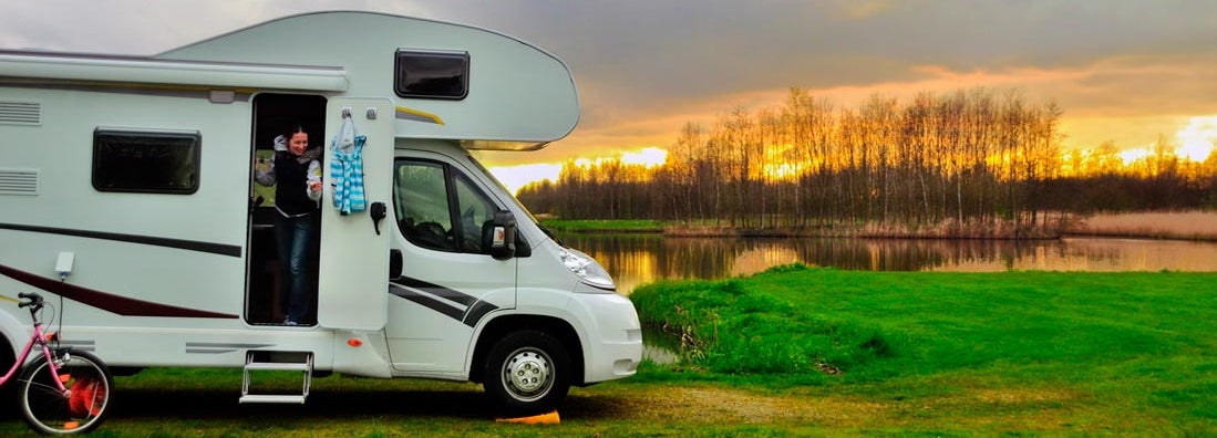 Woman in RV camping at sunset on vacation. Find Georgia RV Insurance.