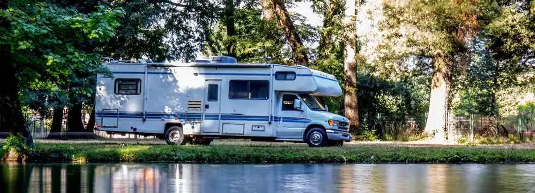 Family trip in motorhome in forest in Maine. Find Maine RV Insurance.