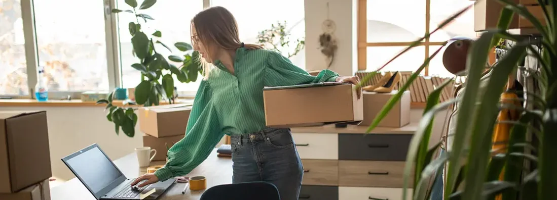 Woman accepting new orders in her online fashion shop. Find Whitefish Bay, Wisconsin business insurance.