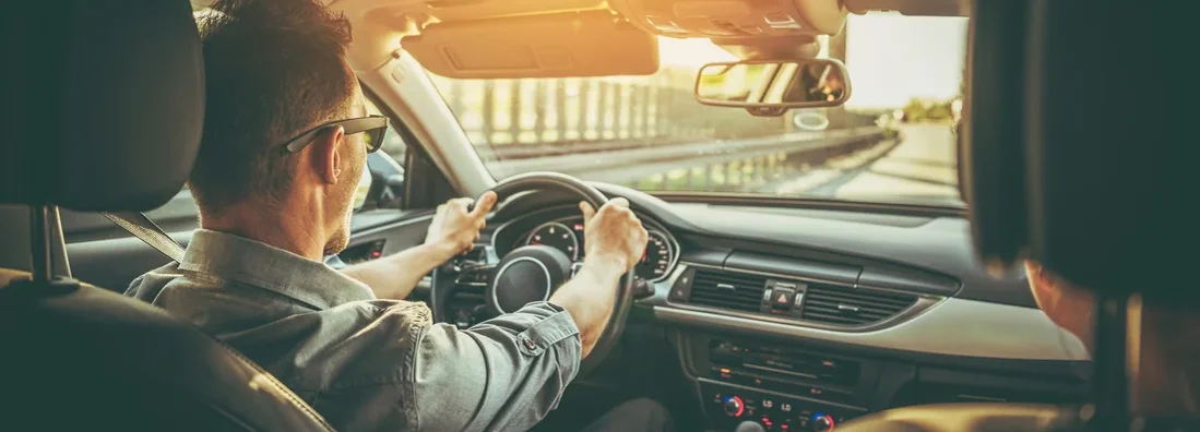 Couple on the Road Trip in Car with Large Sunroof. How to Find the Best Car Insurance in Sheridan, WY. 