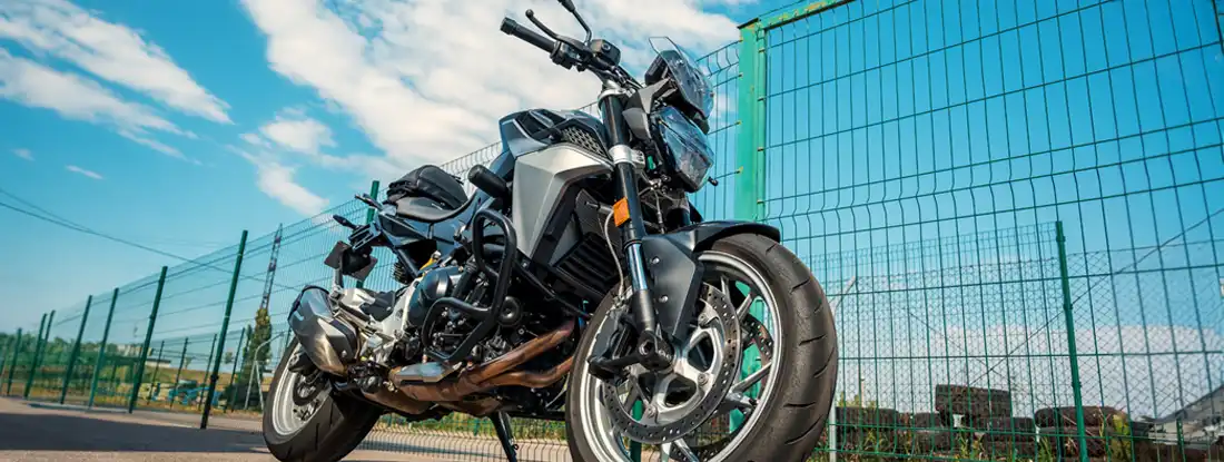 Racing motorcycle parked near the fence. Average Cost of Motorcycle Insurance.