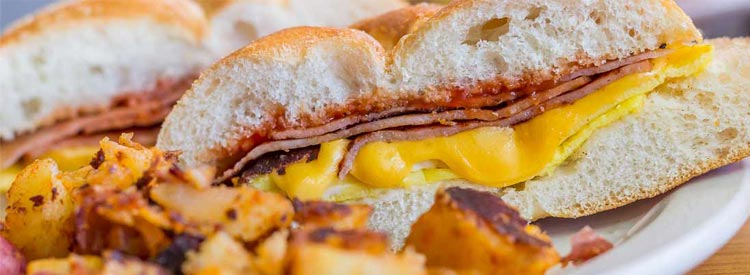 Taylor ham, pork roll, egg and cheese breakfast sandwich with home fries from New Jersey