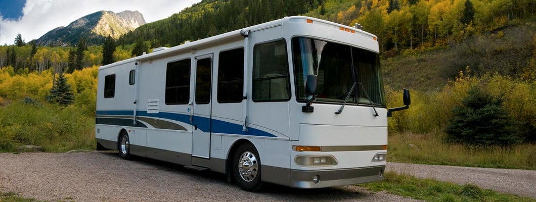 Motorhome sits in a beautiful mountain campground. Find Nevada RV Insurance.