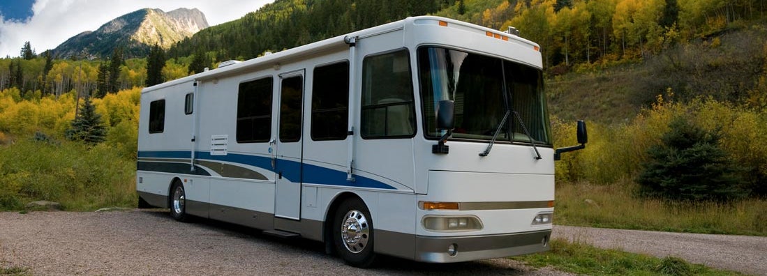 Motorhome sits in a beautiful mountain campground. Find Nevada RV Insurance.