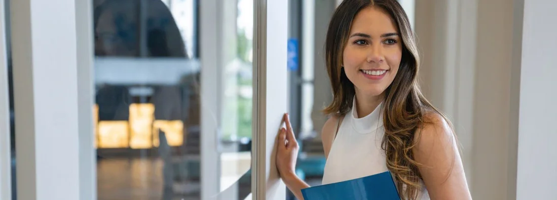 Happy Real Estate Agent showing a house. Find Vermont Landlord Insurance.