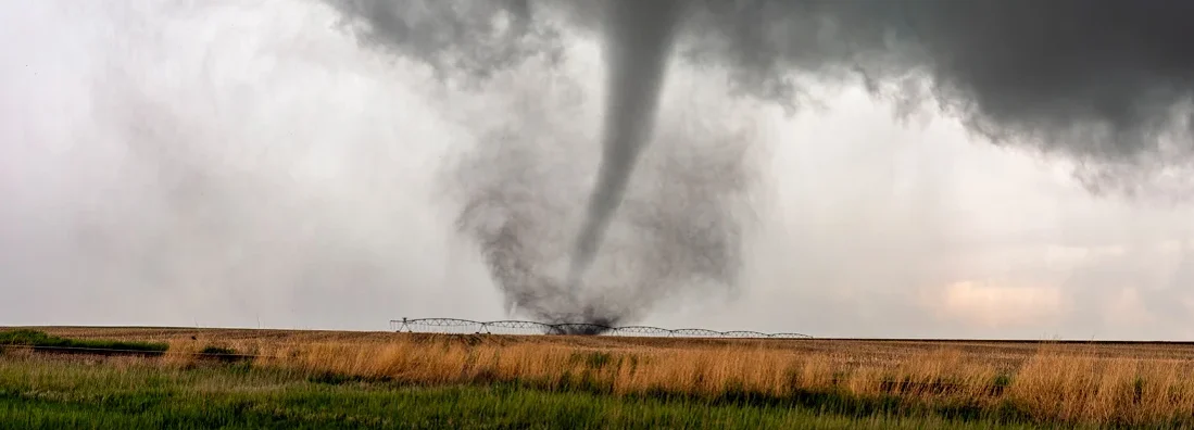 A tornado spins in a field beneath a supercell thunderstorm during a severe weather event in the midwest. 16 Absolutely Essential Tornado Survival Tips for South Dakota.