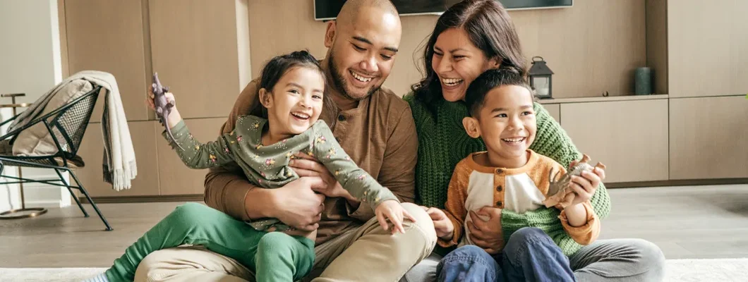 Happy family at home on winter holidays. Find Massachusetts Life Insurance.