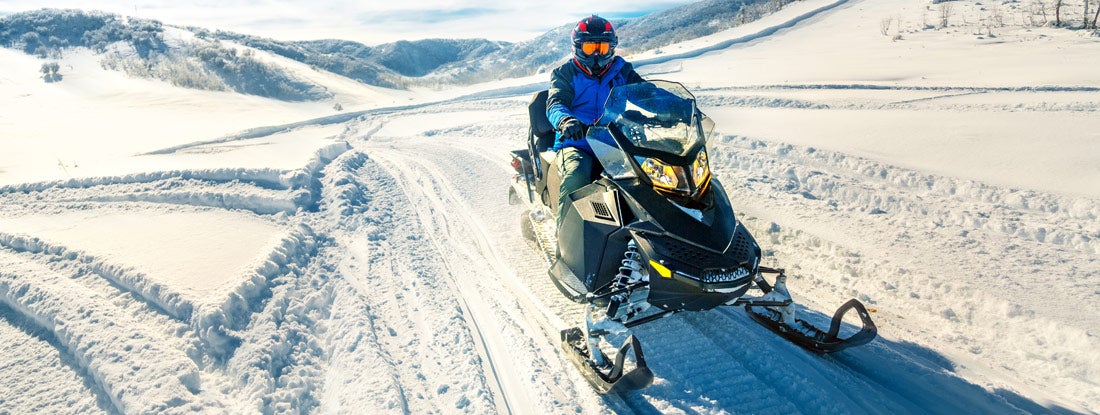 man driving snowmobile