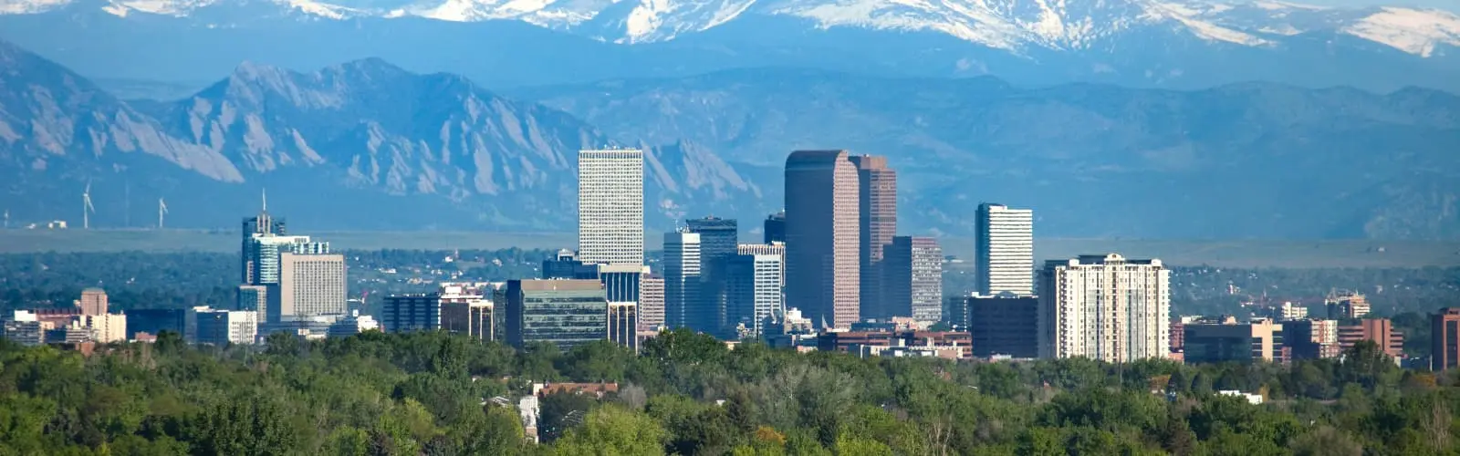 Denver Colorado skyscrapers snowy Longs Peak Rocky Mountains. Find Colorado insurance.